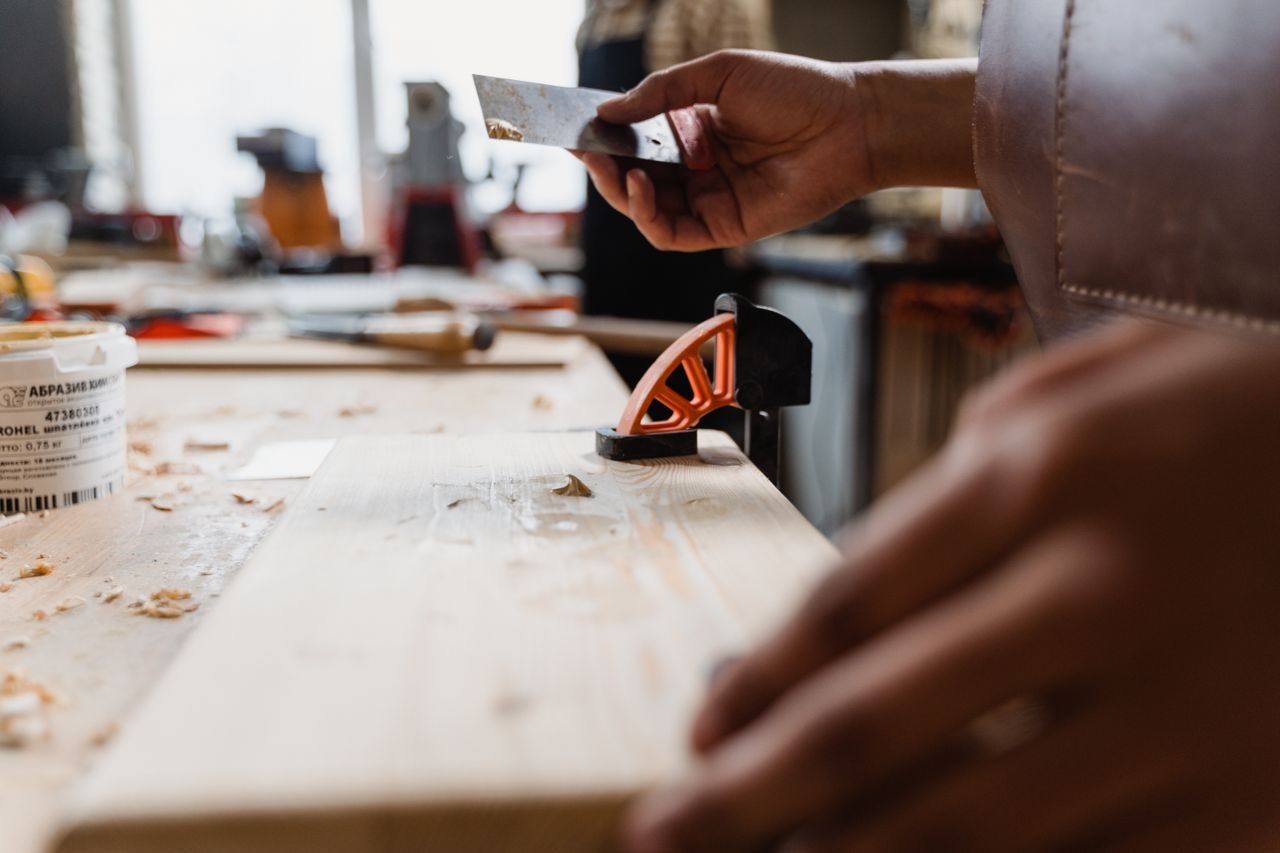 Close-up of a craftsmans hands at work in a woodworking studio. Precision and skill on display.